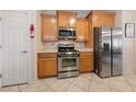 Functional kitchen with stainless steel appliances, wood cabinetry, and a clean, well-lit space at 6114 Saddle Horse Ave, Las Vegas, NV 89122