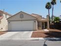 Charming single-story home featuring desert landscaping, a classic design, and an attached two-car garage at 7542 Mycroft Ct, Las Vegas, NV 89147