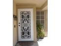 Close-up of the home's entryway, showcasing a decorative security door and a well-maintained facade at 7542 Mycroft Ct, Las Vegas, NV 89147