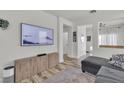 Comfortable living room featuring a large television and an open floor plan at 7706 Crystal Village Ln, Las Vegas, NV 89113