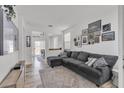 Cozy living room with a large sectional sofa and curated gallery wall at 7706 Crystal Village Ln, Las Vegas, NV 89113