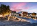 Gorgeous single-story home with stone accents, modern lighting, and desert landscaping at 7966 W Ford Ave, Las Vegas, NV 89113