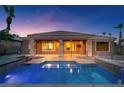 Backyard showcasing a private pool, covered patio, and stone accents on the home's exterior at 8209 Chapelle Ct, Las Vegas, NV 89131