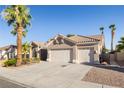 Charming single-story home featuring desert landscaping, a three-car garage, and a tile roof at 8537 Highland View Ave, Las Vegas, NV 89145