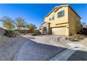 Charming two-story home with a paver driveway and desert landscaping at 8992 Sparkling River Ct, Las Vegas, NV 89178