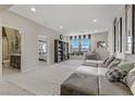 Spacious upstairs room with a large sectional couch, a built-in bookshelf, and plenty of natural light at 8992 Sparkling River Ct, Las Vegas, NV 89178