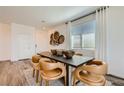 Bright dining room with modern furniture, decor, and natural light from large windows at 9357 Aria Ridge Ave, Las Vegas, NV 89143