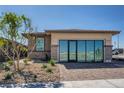 Inviting single-story home boasts desert landscaping and sliding glass doors at 9357 Aria Ridge Ave, Las Vegas, NV 89143