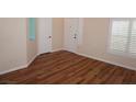 Bright entryway featuring wood-look floors, white trim, and a front door with sidelights at , Las Vegas, NV 89130