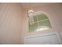 Stylish light fixture hangs near an arched window above the front door, illuminating the foyer at , Las Vegas, NV 89130