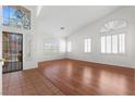 Bright and airy living room featuring neutral walls, wood floors and plenty of windows at 1132 Coral Desert Dr, Las Vegas, NV 89123