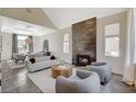 Stylish living room featuring modern furnishings, a fireplace, and an adjoining dining area at 1266 Imperia Dr, Henderson, NV 89052
