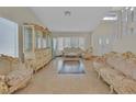 Bright living room with tile flooring, bay window, and elegant, ornate furnishings at 1517 Kirby Dr, Las Vegas, NV 89117