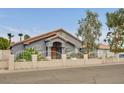 Charming single-story home showcasing a decorative iron gate, tile roof, and manicured landscaping at 1970 Del Font Ct, Las Vegas, NV 89117