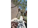 Exterior staircase leading to a condominium unit, surrounded by landscaped walkway at 2000 Gravel Hill St # 203, Las Vegas, NV 89117