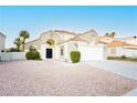 Charming single-Gathering home featuring a well-maintained front yard with desert landscaping and a two-car garage at 2107 Fountain Springs Dr, Henderson, NV 89074