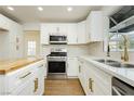 Bright kitchen featuring stainless steel appliances, stylish white cabinetry and hardware, and butcher block island at 2107 Fountain Springs Dr, Henderson, NV 89074