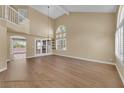 Bright living room showcasing tall ceilings, hardwood floors, and windows with plantation shutters at 2417 Chestnut Hill St, Las Vegas, NV 89134