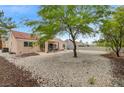 Expansive backyard featuring a covered patio, lush trees, and a serene outdoor living space at 2430 Sungold Dr, Las Vegas, NV 89134