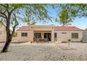 Charming backyard with covered patio, swing, seating, and ample space for outdoor relaxation and entertaining at 2430 Sungold Dr, Las Vegas, NV 89134