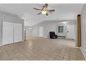 Bright living room with tile floor, ceiling fan, and natural light, featuring access to the backyard at 2432 Shady Hill Ave, Las Vegas, NV 89106