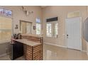 Bright foyer with tile floors, a staircase, and a bar area for entertaining at 2621 Rainbow Glow St, North Las Vegas, NV 89030