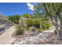 Exterior view showcasing the home's landscaping, walkway, and convenient covered parking at 2761 Carnation Ln # 1, Henderson, NV 89074