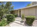 Inviting front entrance with a well-maintained walkway and beautiful, mature shrubbery at 2761 Carnation Ln # 1, Henderson, NV 89074