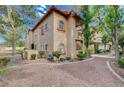 Charming two-story condo exterior featuring well-maintained landscaping and a welcoming facade at 2925 Wigwam Pkwy # 123, Henderson, NV 89074