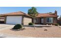Charming single-story home boasts a red tile roof and low-maintenance desert landscaping at 391 Newbury Ct, Henderson, NV 89015