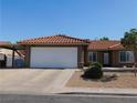 Charming home with a two-car garage and low-maintenance front yard and red tile roof at 391 Newbury Ct, Henderson, NV 89015
