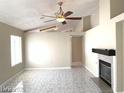 Bright living room with a fireplace, ceiling fan, and lots of natural light at 4021 Broadriver Dr, Las Vegas, NV 89108