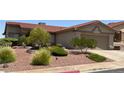 A well-landscaped front yard with mature trees, bushes, and rocks adding character to the property at 416 Richgold St, Henderson, NV 89012