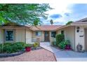 Inviting home exterior with well-maintained landscaping and a welcoming front entrance at 4161 Royalhill Ave, Las Vegas, NV 89121