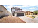 Two-story home featuring a gray exterior and a two-car garage at 4657 Curdsen Way, Las Vegas, NV 89110
