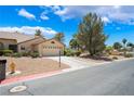 Charming single-story home with a well-maintained front yard and attached two-car garage at 4909 Desert Poppy Dr, Las Vegas, NV 89130