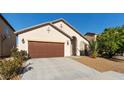 Inviting single-story home featuring a two-car garage, desert landscaping and an arched entry at 4916 White Jade St, North Las Vegas, NV 89081