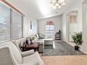 Sunlit living room boasts neutral paint, large windows, and a comfortable seating arrangement at 4916 White Jade St, North Las Vegas, NV 89081