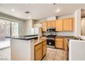 Well-lit kitchen featuring granite countertops, stainless steel appliances, and ample cabinet space at 5021 Ropers Rock Ct, Las Vegas, NV 89131