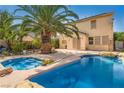 Backyard with a sparkling blue pool, mature landscaping and a spacious patio for outdoor entertaining at 5021 Ropers Rock Ct, Las Vegas, NV 89131