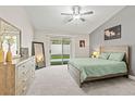 Serene main bedroom features plush carpeting and sliding glass door to backyard at 5108 Molveno Ct, Las Vegas, NV 89130