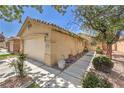 Charming single-story home featuring a well-manicured front yard and a two-car garage at 5687 Harbour Pointe Ave, Las Vegas, NV 89122