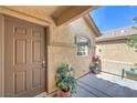 Inviting front porch with a potted plant and outdoor seating for enjoying the fresh air at 5687 Harbour Pointe Ave, Las Vegas, NV 89122