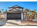 Charming two-story home featuring a spacious two-car garage and mature palm trees at 5825 Bent Branch Ln, Las Vegas, NV 89142