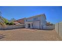 Spacious backyard ready for landscaping with a quaint brick patio and tall concrete block wall at 6042 Thorne Bay Ct, Las Vegas, NV 89110