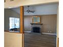Inviting living room features a classic fireplace, hardwood floors, and a ceiling fan at 6241 Pinewood Ave, Las Vegas, NV 89103