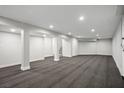 Finished basement featuring neutral carpet, support columns, and access to stairs at 7060 W Rome Blvd, Las Vegas, NV 89131