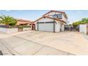 Charming two-story home featuring a well-maintained lawn, driveway, and Spanish style roof at 7384 Valhalla Ln, Las Vegas, NV 89123