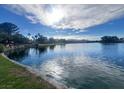 Picturesque view of the lake featuring a lush shoreline and serene atmosphere at 7641 Tortola Bay Ln, Las Vegas, NV 89128