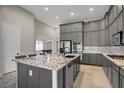 Modern kitchen with granite countertops, stainless steel appliances, and ample cabinet space at 8544 Garden Valley Ct, Las Vegas, NV 89178